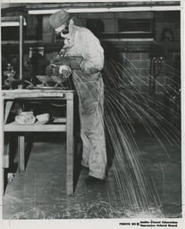 Student welding at a table
