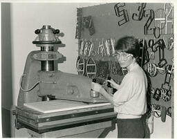 Student at a machine with wire numbers on wall