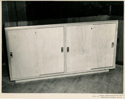 Wooden cabinet with sliding doors, ca. 1954