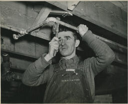 Plumbing student working on pipe, ca. 1949