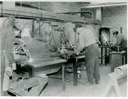 Welding students working at a machine