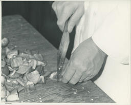 Close-up of hand chopping peppers