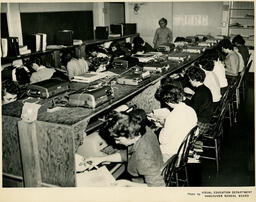 Students working on transcription in wooden cubicles, ca. 1960