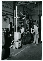 Engineering students work on machines