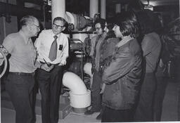 Students on a tour of trades listening to instructors