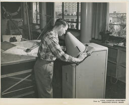 Navigation student looks through navigation tool, ca. 1959