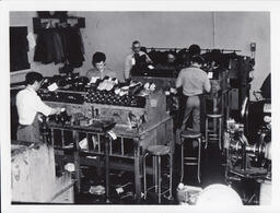 Students working at shoe repair benches