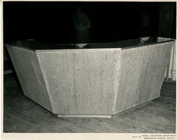 A wooden reception-style desk, ca. 1954
