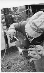 Student welding with a torch
