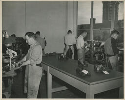 Five students working at shoe repair machines, ca. 1949