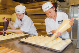 2 baking students piping