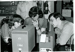 Students looking at a piece of equipment